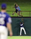 Texas Rangers center fielder Delino DeShields looks up at a home run by Tampa Bay Rays' Austin Meadows during the eighth inning of a baseball game Tuesday, Sept. 10, 2019, in Arlington, Texas. (AP Photo/Richard W. Rodriguez)