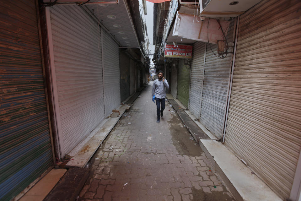 A Pakistani man walks through a main market which is closed due to a strike in Rawalpindi, Pakistan, Saturday, July 13, 2019. Pakistani traders have largely kept their business shut across the country against the new sales tax regime in the first budget of the new government they and opposition parties said came on the diktat of International Monetary Fund in turn of a $6bn bailout package. (AP Photo/Anjum Naveed)