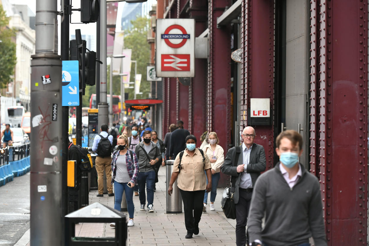 People exit Waterloo station in London, after Prime Minister Boris Johnson announced a range of new restrictions to combat the rise in coronavirus cases in England. (Photo by Dominic Lipinski/PA Images via Getty Images)