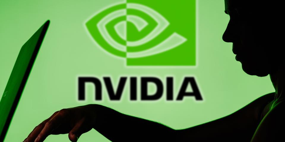 Nvidia logo with a shadow of a person on a laptop in front of it