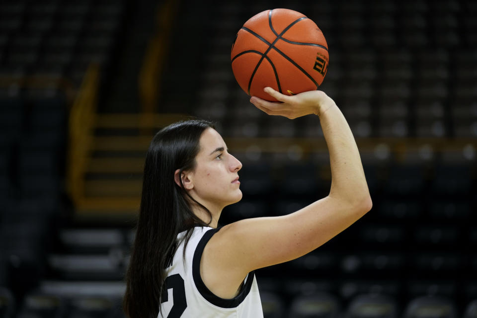 Iowa guard Caitlin Clark poses for photographers during Iowa's NCAA college basketball media day Oct. 4, 2023, in Iowa City, Iowa. Clark is embracing her role as an ambassador for the game after she led Iowa to the NCAA championship game last season. She enters this season with 90 straight double-figure scoring games and a 27.3-point career average. (AP Photo/Charlie Neibergall)