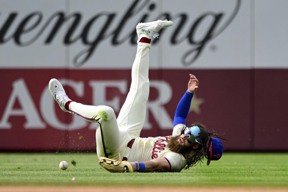 Philadelphia Phillies' Brandon Marsh is unable to make a catch on a ball hit by Atlanta Braves' Austin Riley during the eighth inning of a baseball game Sunday, March 31, 2024, in Philadelphia. (AP Photo/Derik Hamilton)