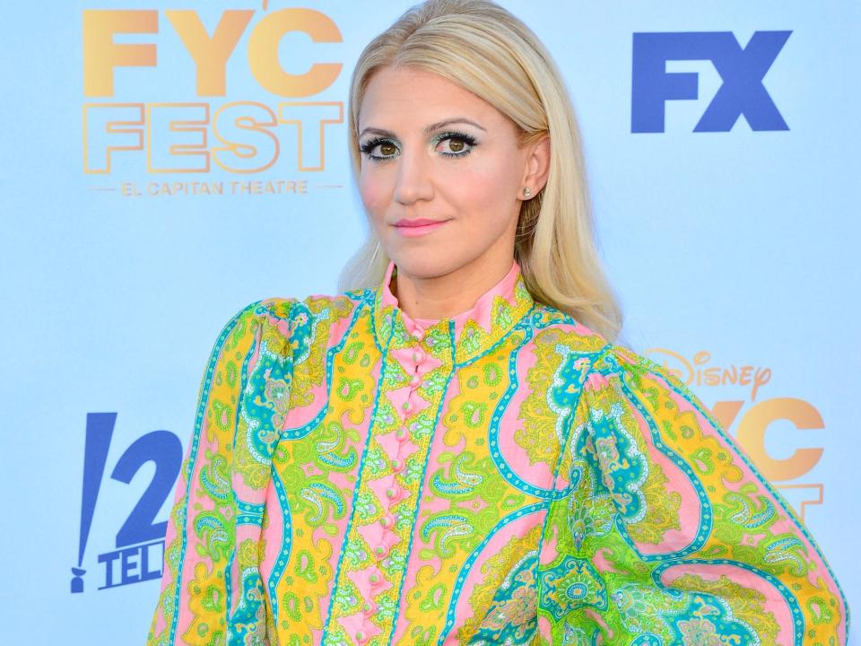 Annaleigh Ashford poses on the red carpet in a multicolored dress.