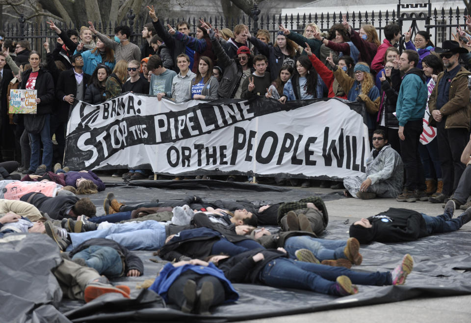 FILE - In this March 2, 2014, file photo, several hundred students and youth who marched from Georgetown University to the White House to protest the Keystone XL Pipeline wait to be arrested outside the White House in Washington. The sponsor of the Keystone XL crude oil pipeline says it's pulling the plug on the contentious project, Wednesday, June 9, 2021, after Canadian officials failed to persuade the Biden administration to reverse its cancellation of the company's permit. . (AP Photo/Susan Walsh, File)