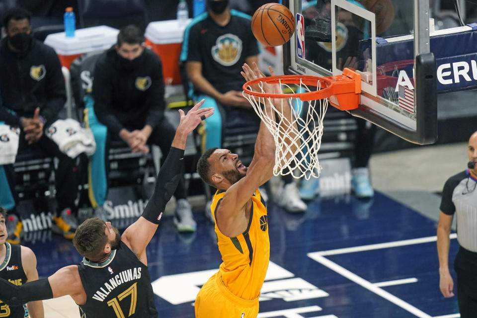 Utah Jazz center Rudy Gobert (27) shoots as Memphis Grizzlies center Jonas Valanciunas (17) defends in the first half during an NBA basketball game Saturday, March 27, 2021, in Salt Lake City. (AP Photo/Rick Bowmer)