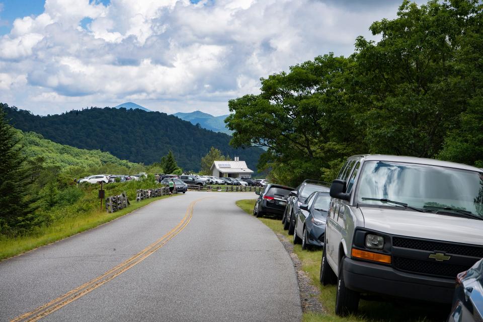 More than a dozen cars park illegally along the Blue Ridge Parkway near the full parking lot at Graveyard Fields on July 13, 2020. 