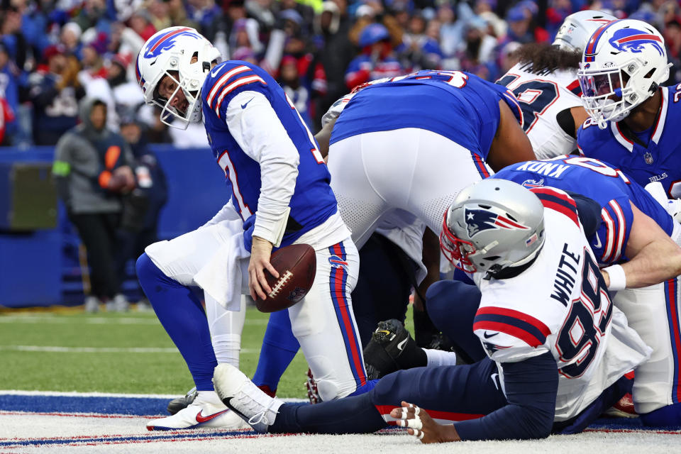 Buffalo Bills quarterback Josh Allen gets up from the pile after scoring a touchdown during the second half of an NFL football game against the New England Patriots in Orchard Park, N.Y., Sunday, Dec. 31, 2023. (AP Photo/Jeffrey T. Barnes )