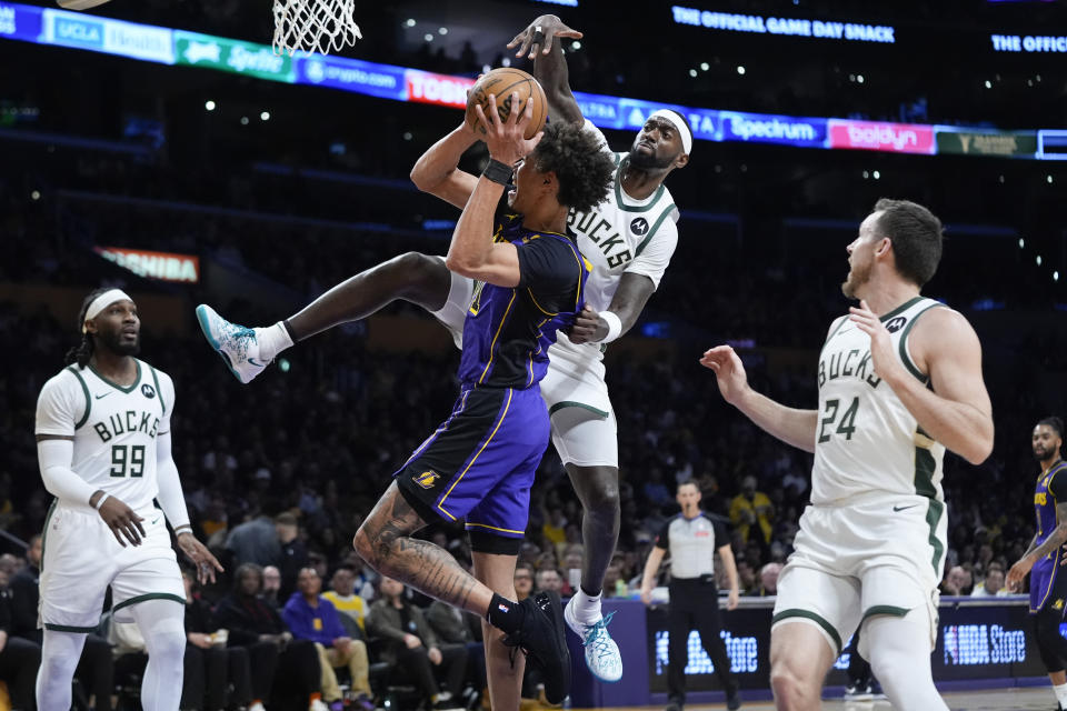 Milwaukee Bucks forward Bobby Portis, center right, fouls Los Angeles Lakers center Jaxson Hayes, center left, during the first half of an NBA basketball game Friday, March 8, 2024, in Los Angeles. (AP Photo/Jae C. Hong)