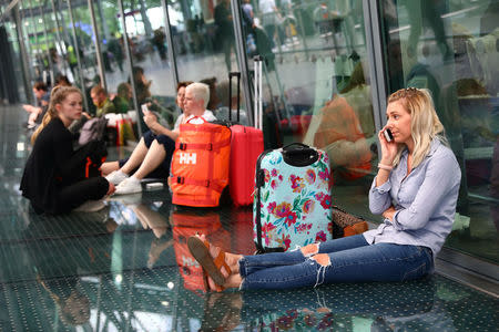 People wait with their luggage at Heathrow Terminal 5 in London, Britain May 27, 2017. REUTERS/Neil Hall