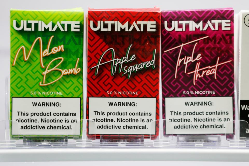 Flavoured e-cigarrette pods are displayed for sale (AP)