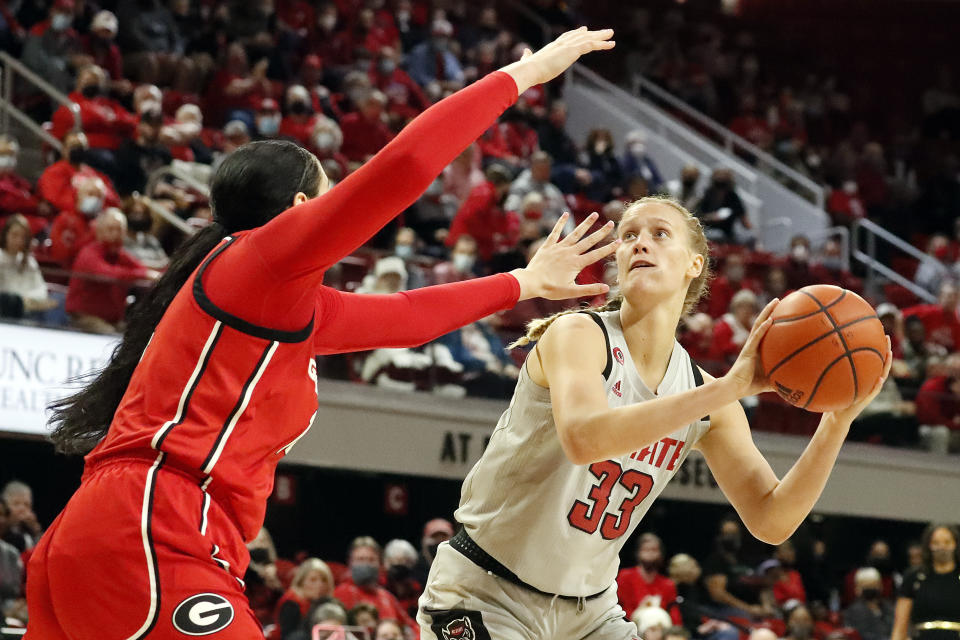 North Carolina State's Elissa Cunane (33) tries to shoot as Georgia's Jenna Staiti (14) defends during the second half of an NCAA college basketball game, Thursday, Dec. 16, 2021, in Raleigh, N.C. (AP Photo/Karl B. DeBlaker)