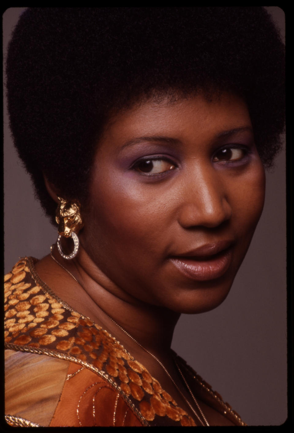 <p>Baby ‘fro, purple eyeshadow, and a fresh face is what makes this shot of Aretha Franklin stand out. (Photo by Anthony Barboza/Getty Images) </p>