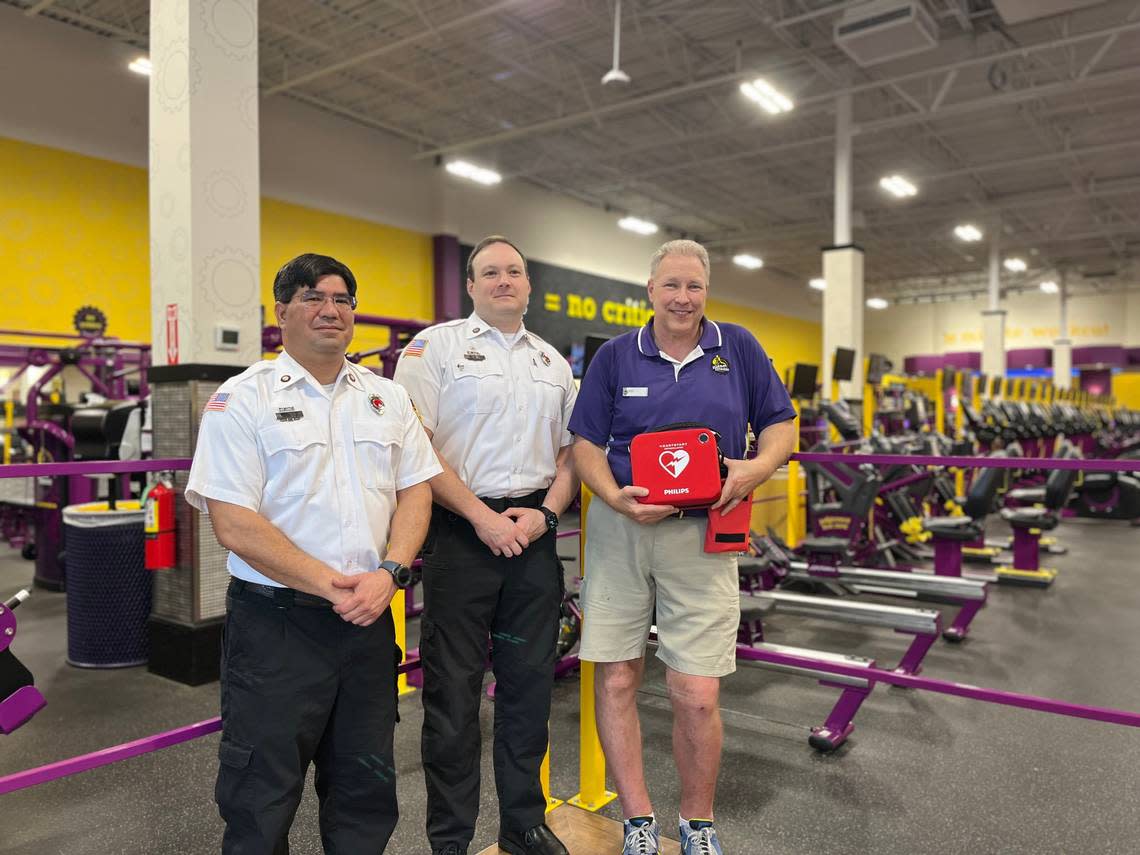 Lt. David Evans, Lt. Adam Jordan and Don Martz pose for a picture at the Beaufort gym where they saved a man who had gone into cardiac arrest Tuesday.