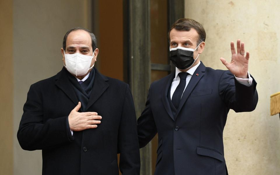 French President Emmanuel Macron (R) welcomes his Egyptian counterpart Abdel Fattah al-Sisi at the Elysee presidential Palace on December 7, 2020 in Paris, for a meeting as part of al-Sisi's a three-day controversial state visit to France, with activists warning Paris not to turn a blind eye to Cairo's rights record with a red carpet welcome. (Photo by Bertrand GUAY / AFP) (Photo by BERTRAND GUAY/AFP via Getty Images) - BERTRAND GUAY/AFP via Getty Images