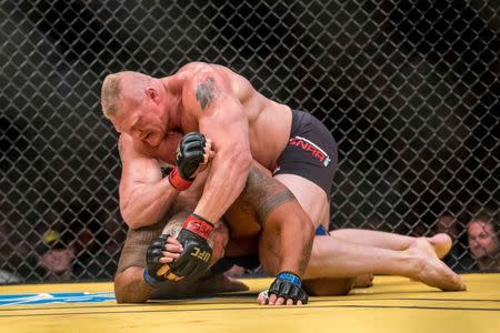 Jul 9, 2016; Las Vegas, NV, USA; Mark Hunt (blue gloves) is elbowed by Brock Lesnar (red gloves) during UFC 200 at T-Mobile Arena. Joshua Dahl-USA TODAY Sports
