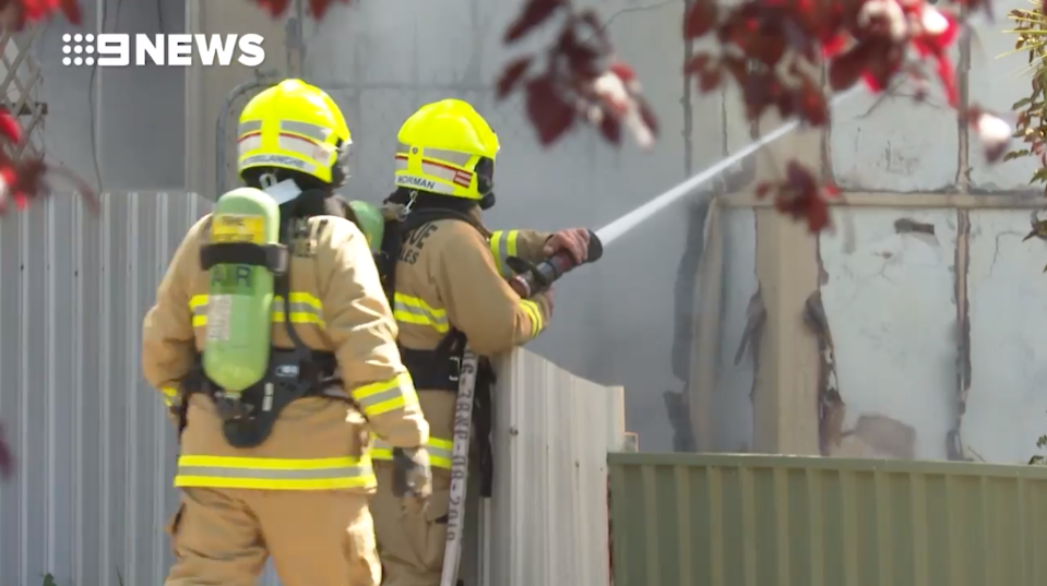 Two firefighters battle a house fire in North Albury.