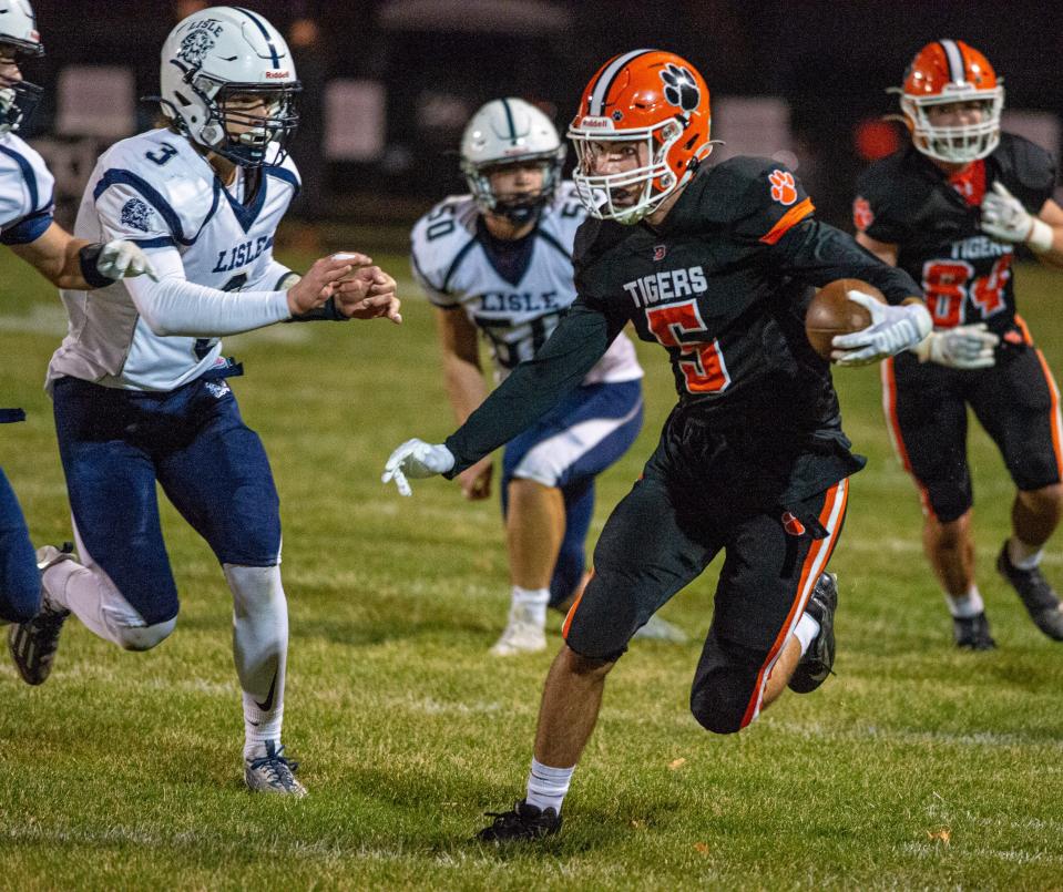 Byron's Ashton Henkel tries to evade the Lisle defense on a run in the first quarter of their first round playoff game in Byron on Friday, Oct. 28, 2022.