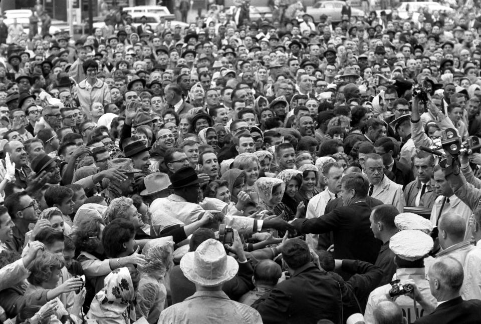 Former U.S. President John F. Kennedy reaches out to the crowd gathered at the Hotel Texas Parking Lot Rally in Fort Worth,Texas, in this handout image taken on November 22, 1963. Friday, November 22, 2013, will mark the 50th anniversary of the assassination of President Kennedy. REUTERS/Cecil Stoughton/The White House/John F. Kennedy Presidential Library  (UNITED STATES: Tags: POLITICS ANNIVERSARY)  ATTENTION EDITORS - THIS IMAGE WAS PROVIDED BY A THIRD PARTY. FOR EDITORIAL USE ONLY. NOT FOR SALE FOR MARKETING OR ADVERTISING CAMPAIGNS. THIS PICTURE IS DISTRIBUTED EXACTLY AS RECEIVED BY REUTERS, AS A SERVICE TO CLIENTS
