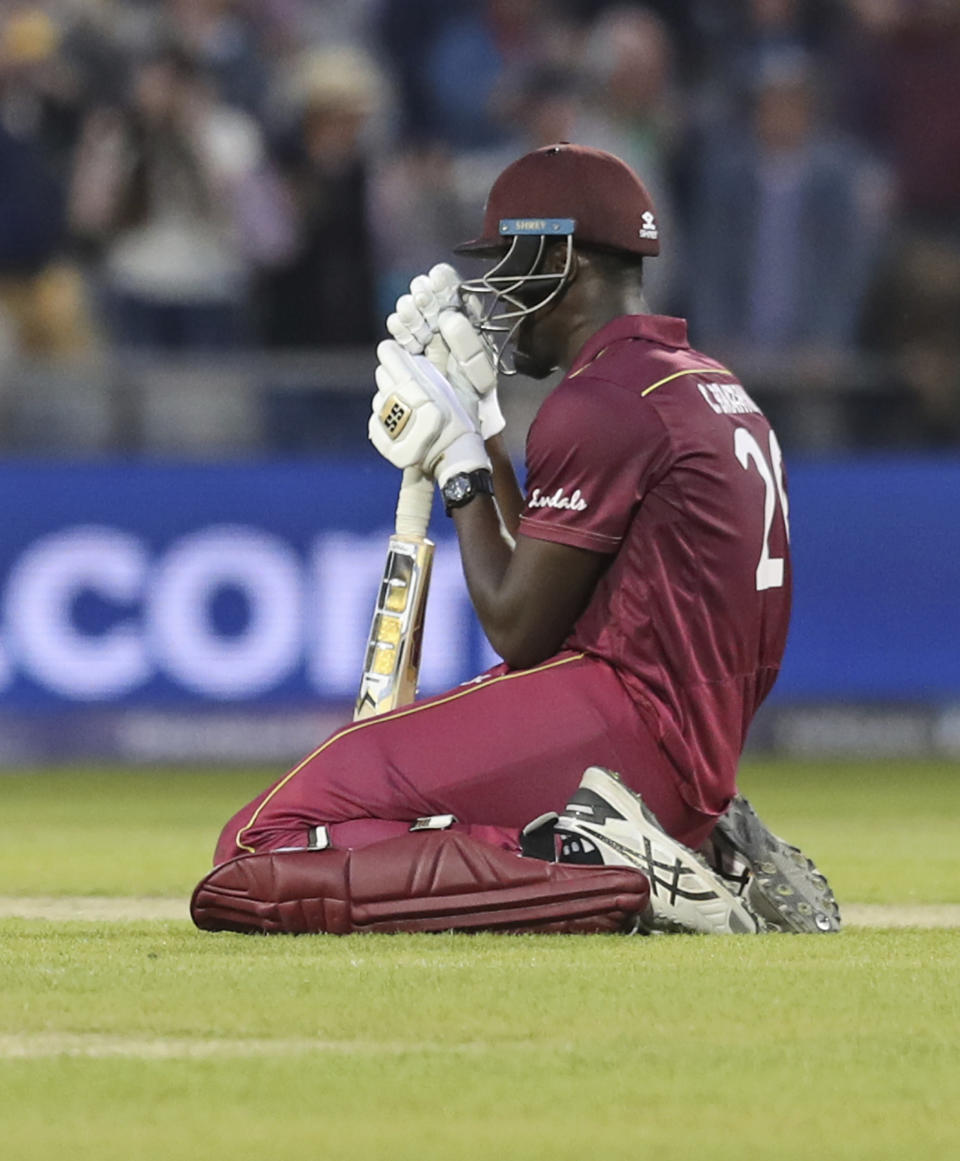 West Indies' Carlos Brathwaite reacts after losing the Cricket World Cup match against New Zealand at Old Trafford in Manchester, England, Saturday, June 22, 2019. (AP Photo/Jon Super)