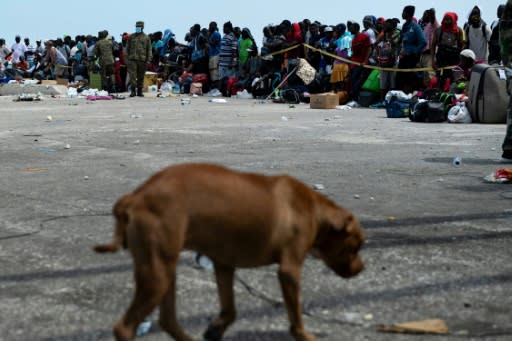 People await evacuation at a dock in devastated Marsh Harbour, Bahamas, on September 7, 2019, in the aftermath of Hurricane Dorian