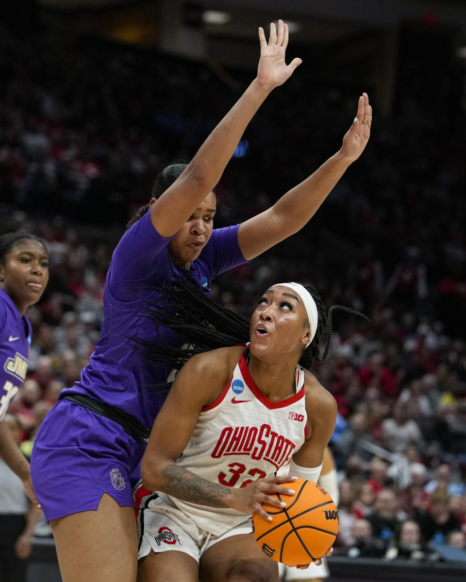 James Madison forward Annalicia Goodman, left, defends Ohio State forward Cotie McMahon (32) as she shoots in the second half of a first-round college basketball game in the women's NCAA Tournament in Columbus, Ohio, Saturday, March 18, 2023. (AP Photo/Michael Conroy)