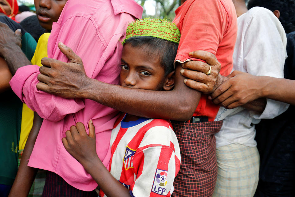 Rohingya refugees stands in a queue for relief supplies