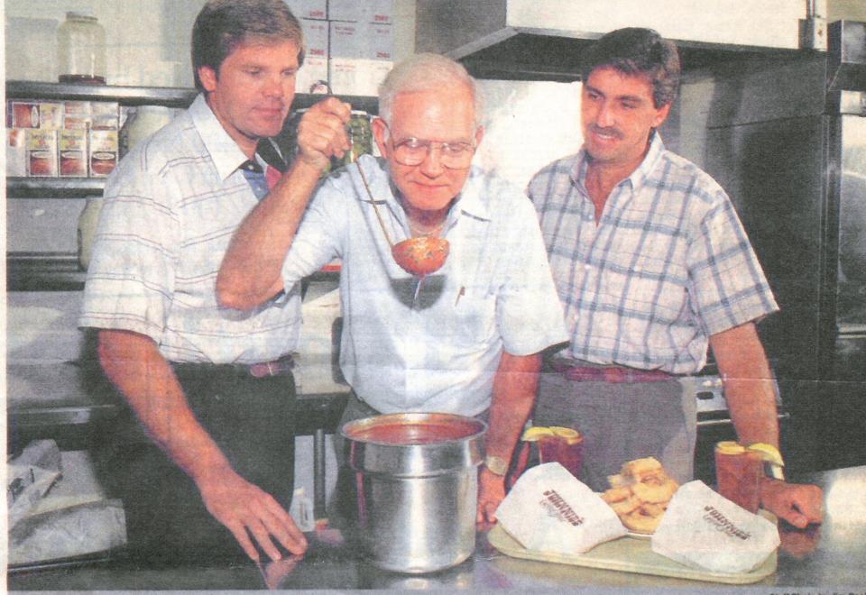 This archival photo depicts, from left, David Haynes, Johnnie Haynes and Rick Haynes in the kitchen checking out the Hik'ry Sauce at Johnnie's Charcoal Broiler in 1987.