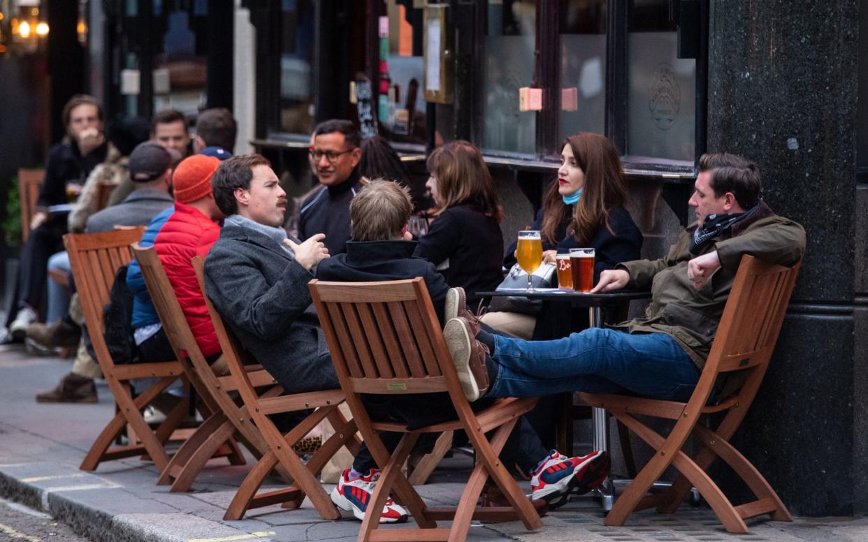  Drinkers outside a pub in Soho, London, on the first day after the city was put into Tier 2 restrictions to curb the spread of coronavirus. PA Photo. Picture date: Saturday October 17, 2020. Under Tier 2 restrictions the rule of six applies for socialising outside, and pubs, bars and restaurants have a 10pm curfew. See PA story HEALTH Coronavirus. Photo credit should read: Dominic Lipinski/PA Wire - Dominic Lipinski/PA Wire