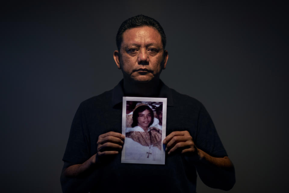 Roland Sondia, 57, holds a photo of himself when he was about 15 years old, the age when he says he was sexually abused by then Archbishop of Agana, Anthony Apuron, in Hagatna, Guam, Friday, May 10, 2019. "I keep asking myself why me," said Sondia. "I keep thinking back to what I could have done to make him want to approach me. I did a good job of hiding it. It's something I'll take to my grave." Apuron denies the allegations, which are detailed in a lawsuit. (AP Photo/David Goldman)