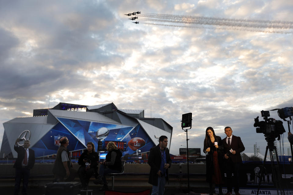 A television broadcast crew prepares to film in front of Mercedes-Benz Stadium ahead of Sunday's NFL Super Bowl 53 football game between the Los Angeles Rams and New England Patriots in Atlanta, Saturday, Feb. 2, 2019. (AP Photo/David Goldman)