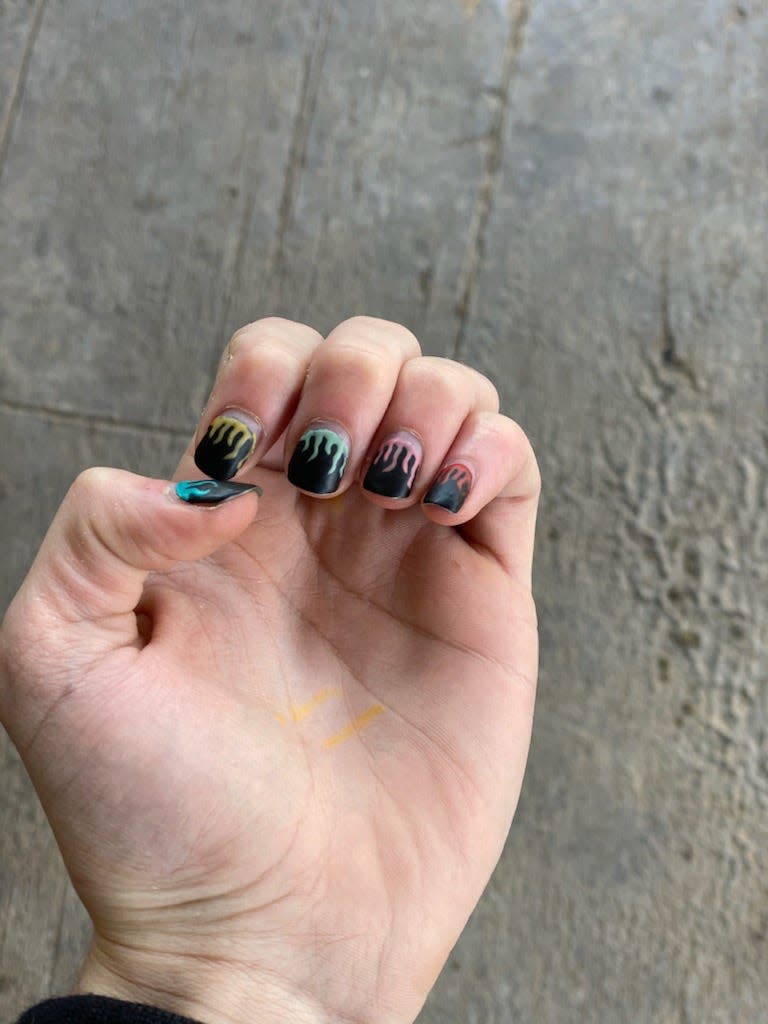 Trevor Wilkinson's fingernails, painted black with different color flames. Wilkinson, 17, is facing suspension from Clyde Consolidated Independent School District because men with painted fingernails violates the district's dress code.