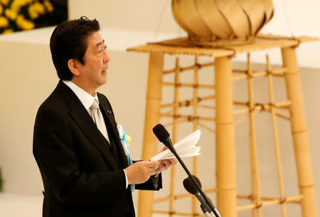 Japan's Prime Minister Shinzo Abe makes a speech during a memorial ceremony marking the 72nd anniversary of Japan's surrender in World War Two, at Budokan Hall in Tokyo, Japan August 15, 2017. REUTERS/Kim Kyung-Hoon