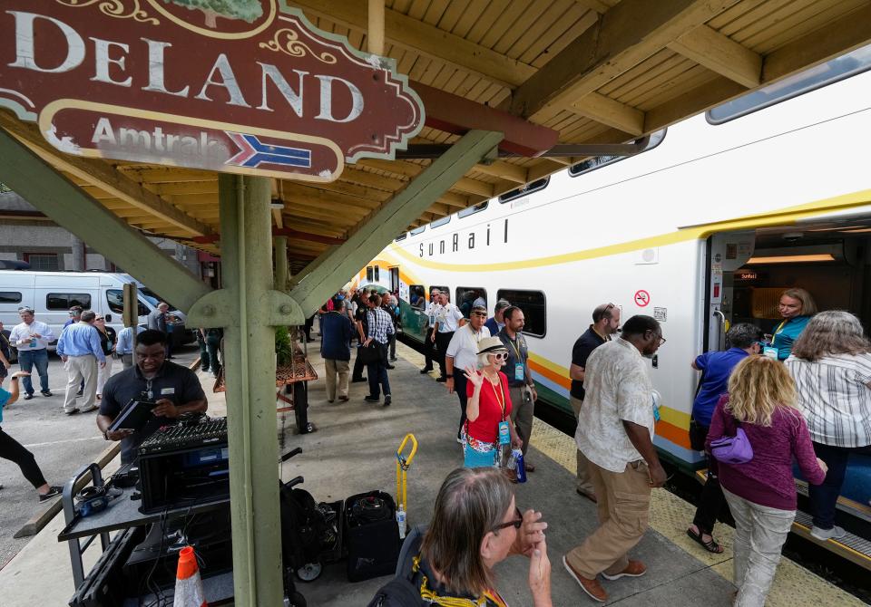 Guests board the SunRail train during a groundbreaking ceremony for the new SunRail expansion station in DeLand, Monday, May 22, 2023. 