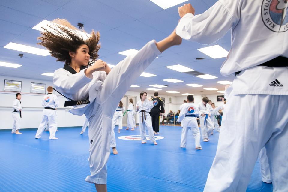 Joshua Aguirre, 11, practices different kicks during an evening training session at Family Karate in Lebanon.