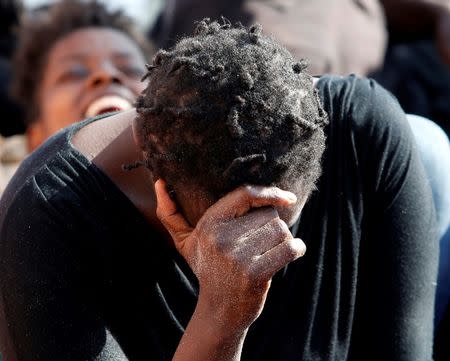 An exhausted migrant rests on the deck of the Migrant Offshore Aid Station (MOAS) ship Topaz Responder after being rescued around 20 nautical miles off the coast of Libya, June 23, 2016. Picture taken June 23, 2016.REUTERS/Darrin Zammit Lupi