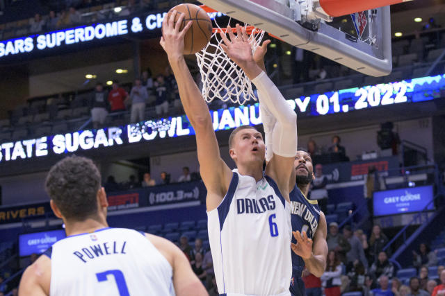 Dallas Mavericks center Kristaps Porzingis (6) shoots against New Orleans Pelicans forward Garrett Temple (41) during the first half of an NBA basketball game in New Orleans, Wednesday, Dec. 1, 2021. (AP Photo/Matthew Hinton)