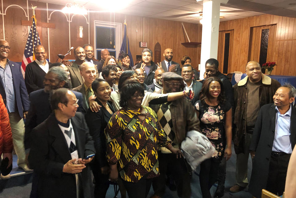 In this Jan. 16, 2020, photo, from left, attendees of a black voter outreach event held by President Donald Trump’s reelection campaign at Philadelphia’s First Immanuel Baptist Church assemble for a group picture after the discussion. Trump’s reelection campaign is reaching out to black voters through one of their communities’ most important institutions — black churches. (AP Photo/Elana Schor)