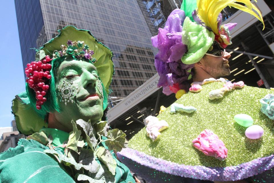Dressed for the occasion, Paul Nagle, left, poses for photographs as he takes take part in the Easter Parade along New York's Fifth Avenue, Sunday, April 20, 2014. (AP Photo/Tina Fineberg)