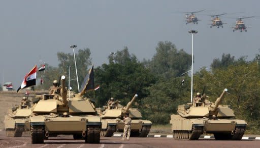 Iraqi army Soviet era Mil Mi-18 helicopters fly over US made Abram tanks during an Army Day parade in central Baghdad in January last year. Iraq's cancellation of a $4.2 bn arms deal is a setback for Moscow's attempts to firm up its slipping foothold in the Middle East and also throws into doubt efforts by Iraq to equip its armed forces