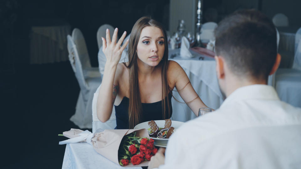 A couple arguing at dinner