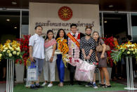 A university student poses for a group photo with family and friends ahead of a graduation ceremony at the Thammasat University, Friday, Oct. 30, 2020, in Bangkok, Thailand. (AP Photo/Sakchai Lalit)