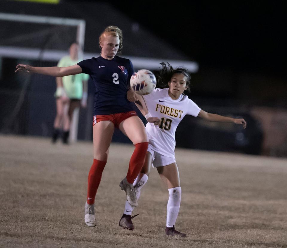 Vanguard High School Addison Fratello (2) battle for the ball and Forest High School Janellie Castillo (10) as Forest travels to Vanguard Thursday, Jan. 19, 2023, at Booster Stadium in Ocala, Fla. [Alan Youngblood/Special to the Ocala Star-Banner]