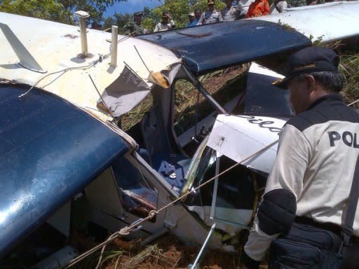 Indonesian search and rescue members examine the wreckage of Susi Air's plane, Pilantus Porter PKVVQ, in Tabang, Balikpapan in East Kaimantan. A South African pilot and his Australian passenger were killed when the plane crashed, in the airline's third fatal accident in a year