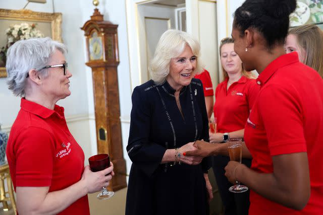 <p>CHRIS JACKSON/POOL/AFP via Getty</p> Queen Camilla meets members of the Maiden yachting crew at Clarence House in London on April 29, 2024.