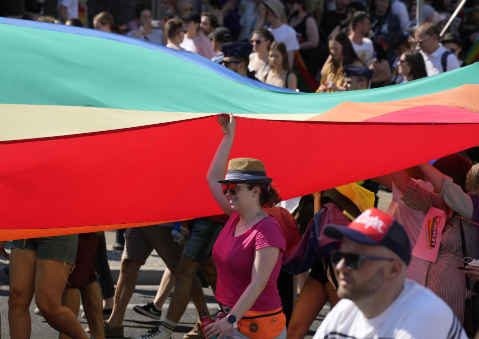 People take part in the Equality Parade, the largest gay pride parade in central and eastern Europe, in Warsaw, Poland, Saturday June 19, 2021. The event has returned this year after a pandemic-induced break last year and amid a backlash in Poland and Hungary against LGBT rights.(AP Photo/Czarek Sokolowski)