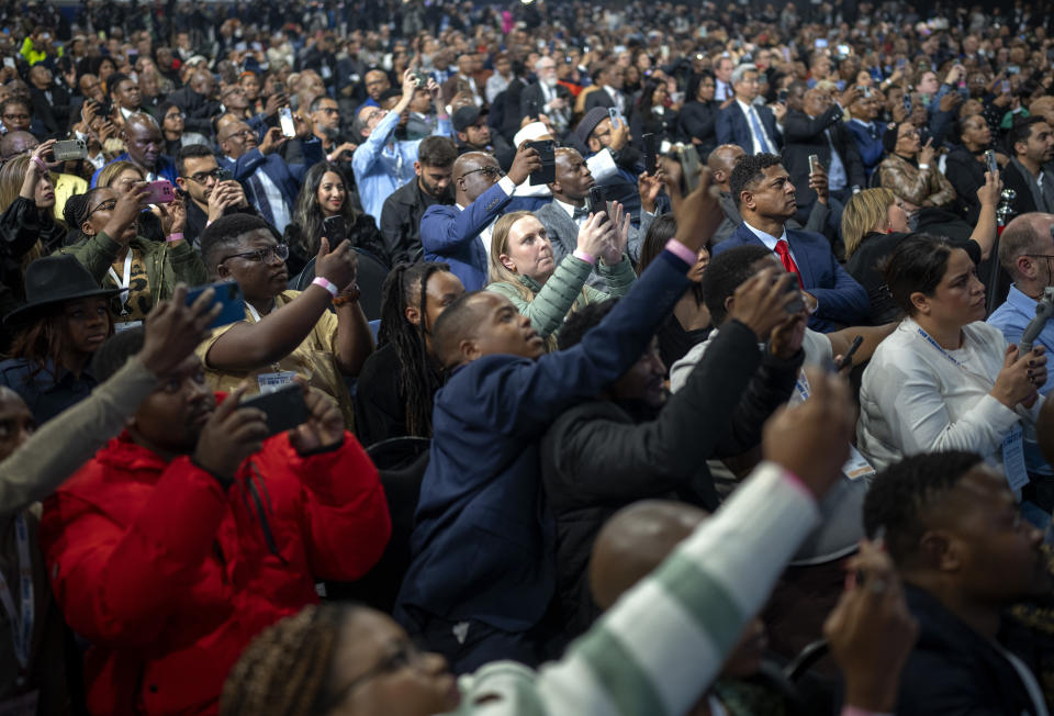 Attendants follow the announcement of the results in South Africa's general elections in Johannesburg, South Africa on Sunday, June 2, 2024. Humbled by a stinging election result, South Africa's African National Congress was talking to everyone in an effort to form a stable coalition government for Africa's most advanced economy after it lost its 30-year majority. (AP Photo/Emilio Morenatti)