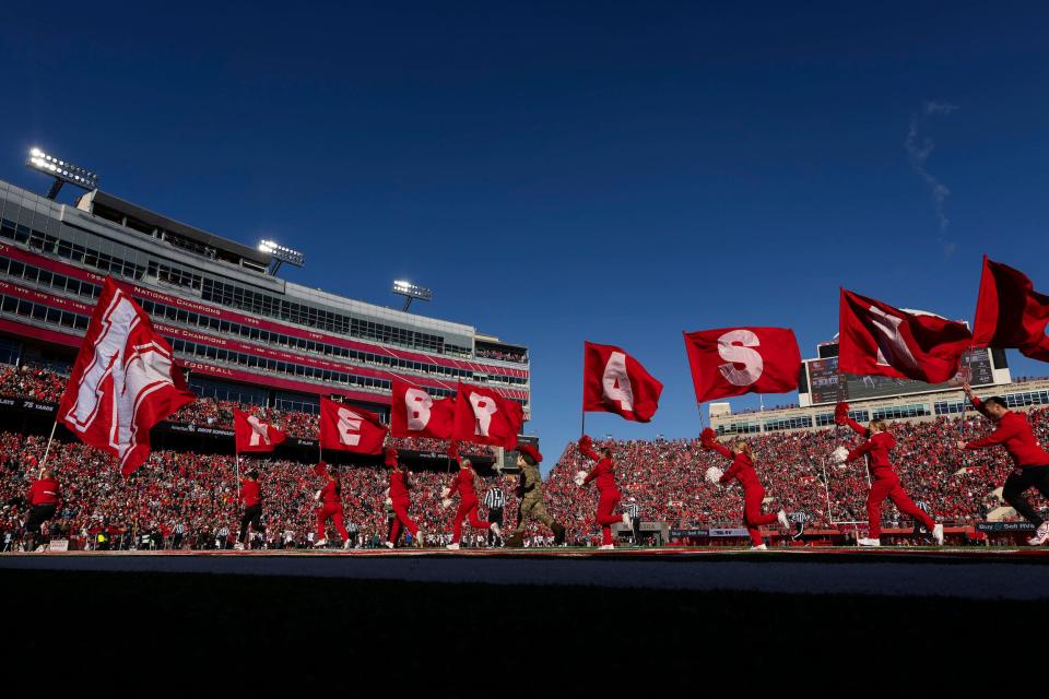 Nebraska cheerleaders wave flags during a game at Memorial Stadium.
