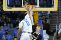 UCLA guard Jaylen Clark (0) dunks the ball against Colorado center Lawson Lovering during the first half of an NCAA college basketball game in Los Angeles, Wednesday, Dec. 1, 2021. (AP Photo/Ashley Landis)