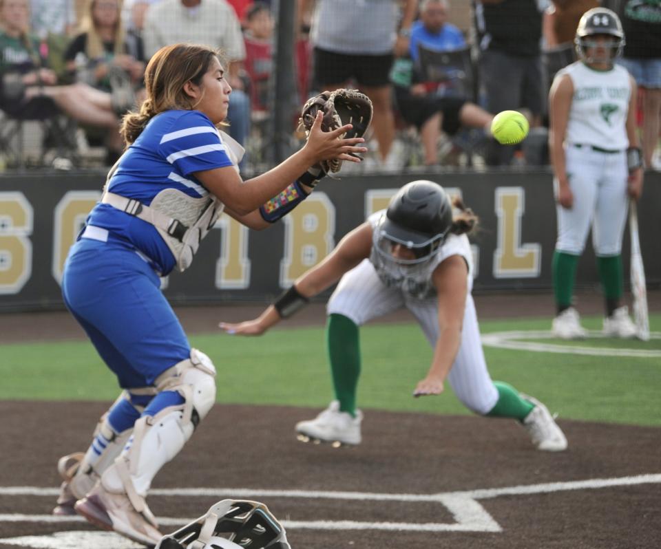 Stamford's Jaylynn Hatley prepares for a play at the plate as Floydada's Carisa Fernandez dives home.