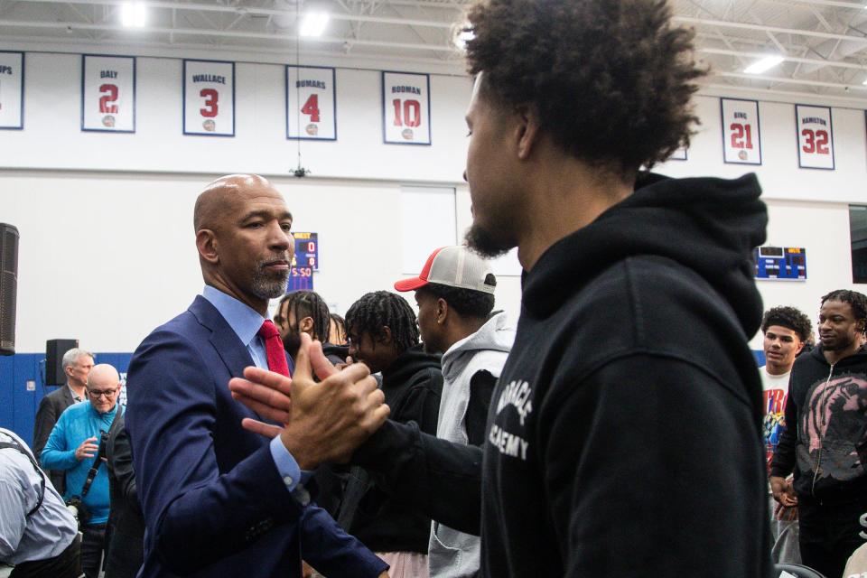 Pistons coach Monty Williams shakes hands with point guard Cade Cunningham during a news conference to introduce Williams as the new head coach at the Pistons Performance Center in Detroit on Tuesday, June 13, 2023.